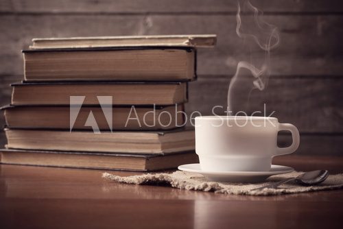 Fototapeta old books on wooden background with cup of coffee