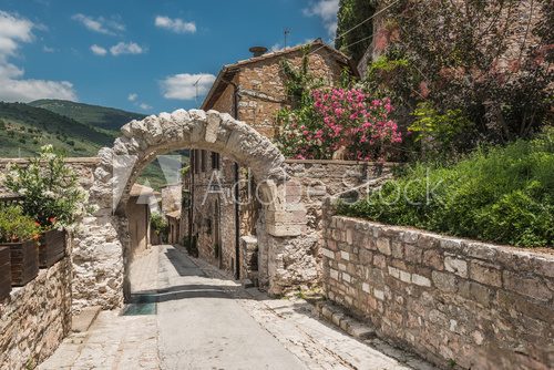 Fototapeta Old rocky arch over the street in Spello, Umbria