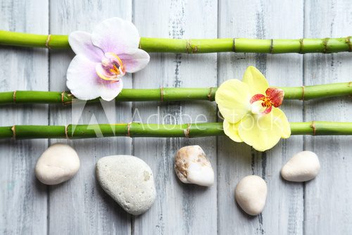 Fototapeta Orchid flowers  and bamboo with pile stones on wooden