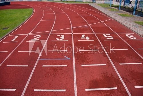 Fototapeta Red running racetrack on the athletic stadium