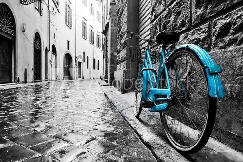 Fototapeta Retro blue bike on old town street.