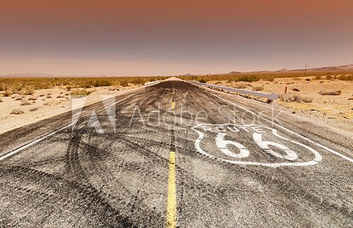 Fototapeta Route 66 pavement sign sunrise in California's Mojave desert.