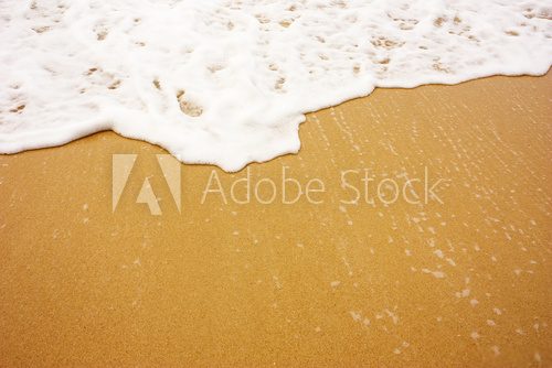 Fototapeta Sea wave with foam on sand