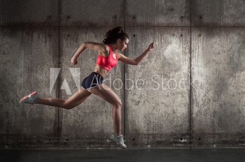 Fototapeta Side view of running woman