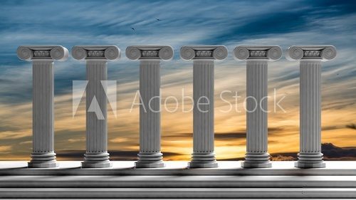 Fototapeta Six ancient pillars with sunset sky background.