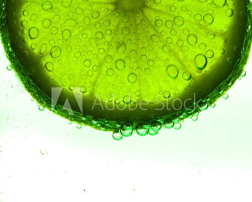 Fototapeta Slice of lime with water drops
