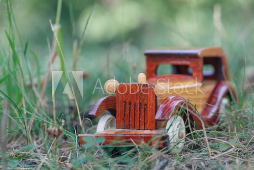 Fototapeta Small wooden toy car in forest
