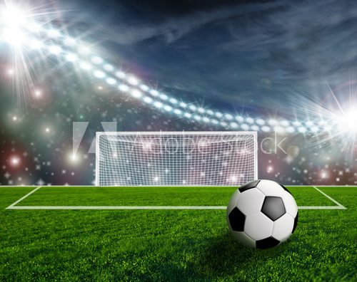 Fototapeta Soccer ball on green stadium arena