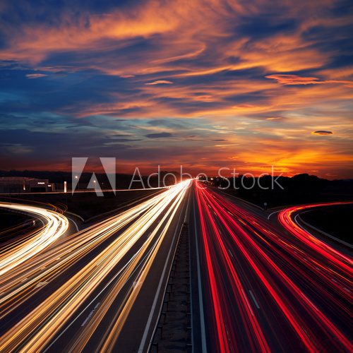 Fototapeta Speed Traffic at Dramatic Sundown Time - light trails