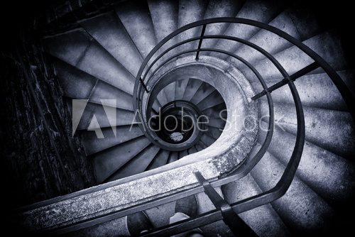 Fototapeta Spiral Staircase Winding Down in Historic Building