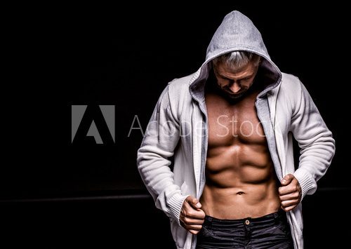Fototapeta strong athletic man on black background