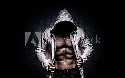 Fototapeta strong athletic man on black background