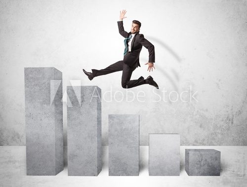 Fototapeta Successful business man jumping over charts on background