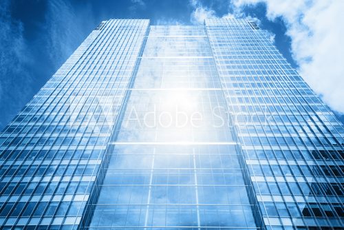 Fototapeta Sun reflecting in modern business skyscraper, high-rise building,