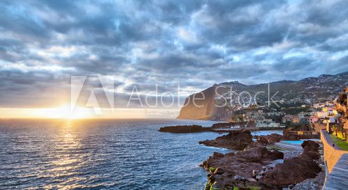 Fototapeta Sunset over Cabo Girao cliff viewed from Camara de Lobos, Madeira, Portugal