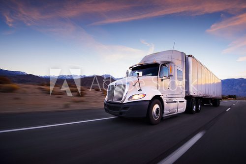 Fototapeta Truck and highway at sunset - transportation background