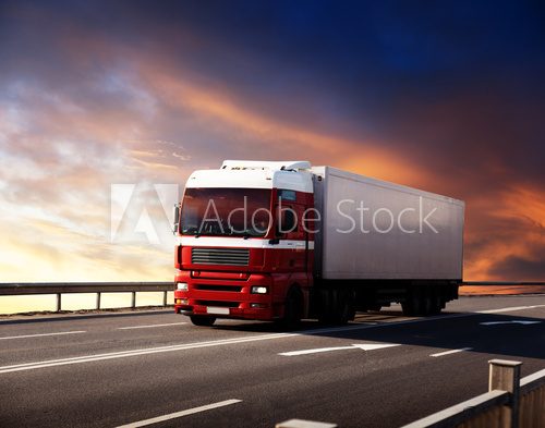 Fototapeta truck on highway and sunset