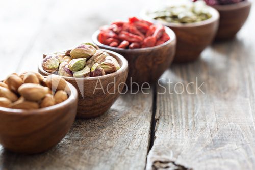 Fototapeta Variety of nuts and dried fruits in small bowls