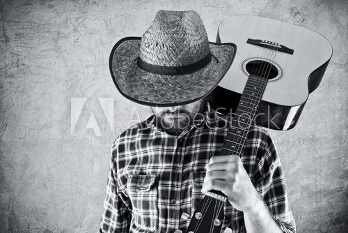 Fototapeta Western country cowboy musician with guitar