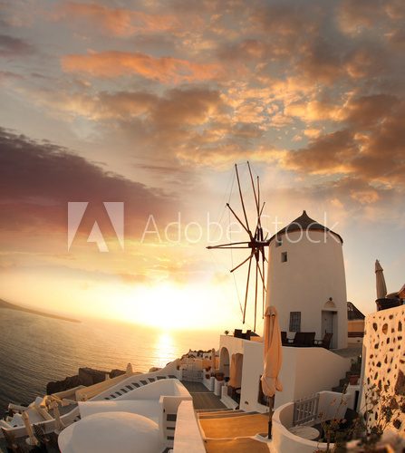 Fototapeta Windmill in Santorini against sunset, Greece