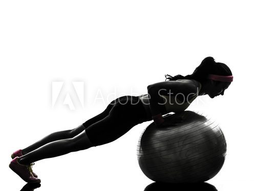 Fototapeta woman exercising fitness workout push ups  silhouette