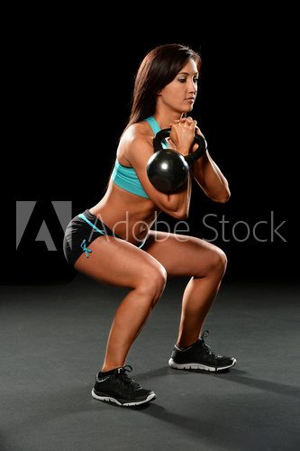 Fototapeta Woman Exercising with Kettlebell